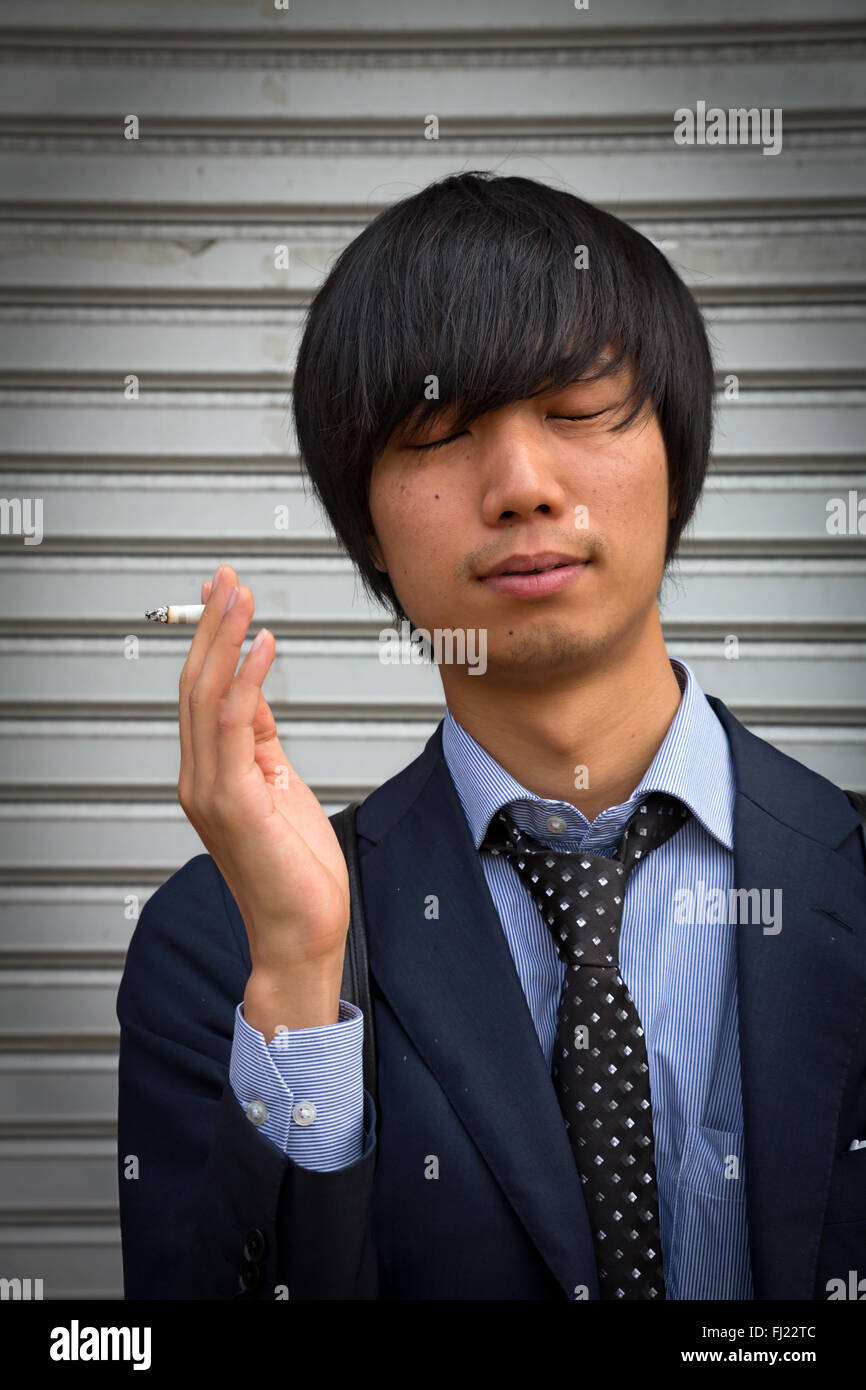 Japanese man smoking in Ossaka Stock Photo