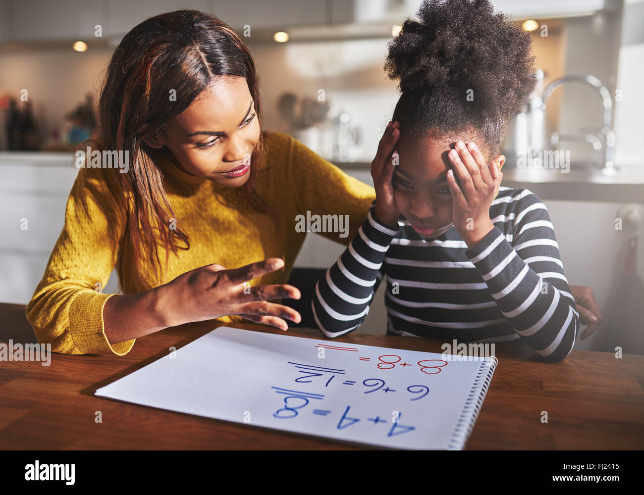 Mother learning her daughter to calculate elementary school work Stock Photo