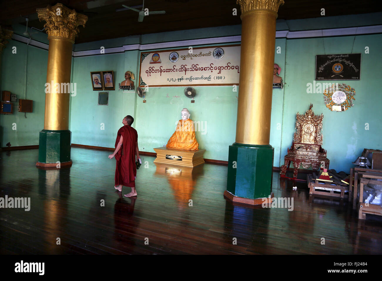 Buddhist monk walking inside Shwedagon Pagoda,  Yangon , Myanmar Stock Photo