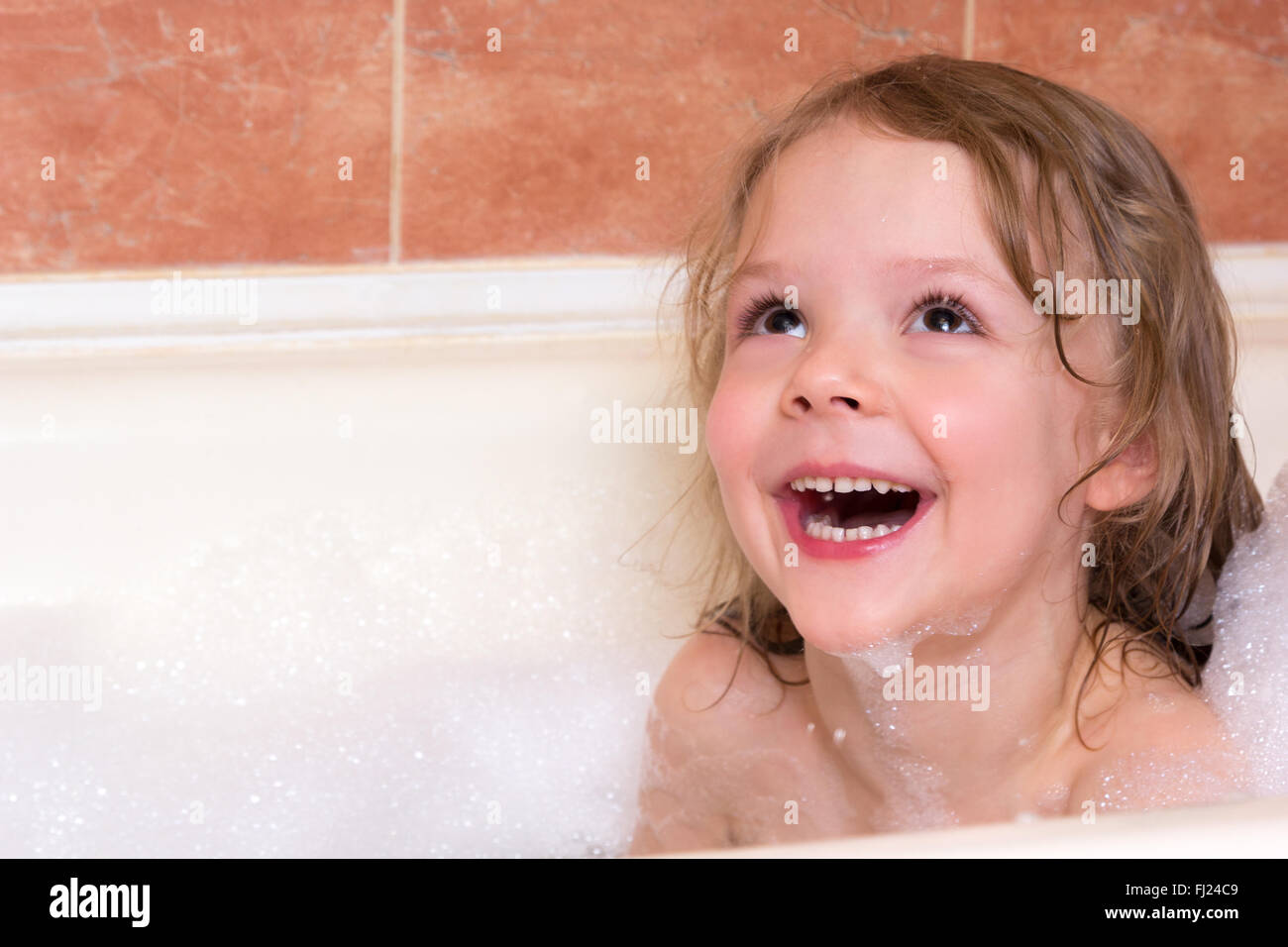 little girl bathes in the bathtub with foam Stock Photo Alamy