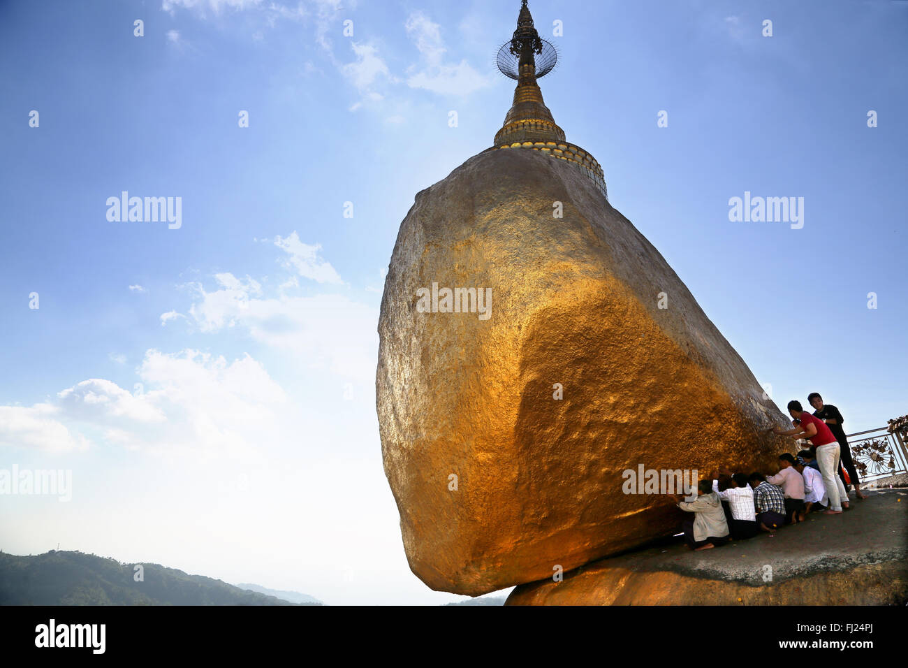 Buddhist Burmese people praying at Kyaiktiyo Pagoda Golden Rock, Myanmar Stock Photo