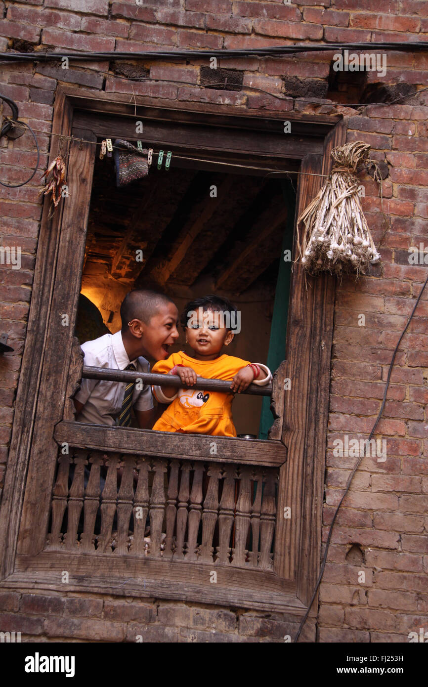 Nepal picture of a child playing with baby on balcony Stock Photo