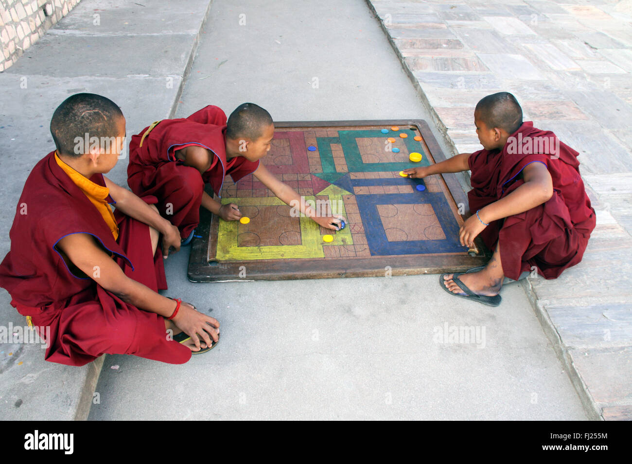Buddhist monks playing in monastery, gompa, in Boudhanath, Nepal Stock Photo