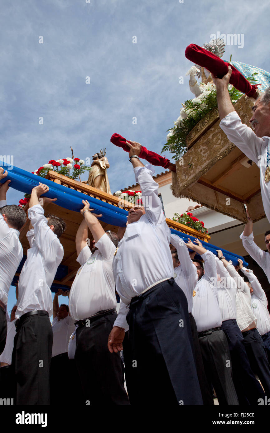 ALMENDRALEJO, SPAIN, APRIL 6: Costaleros rising a float during the last Holy Week Procession or Resurrection Day, Spain, Almendr Stock Photo