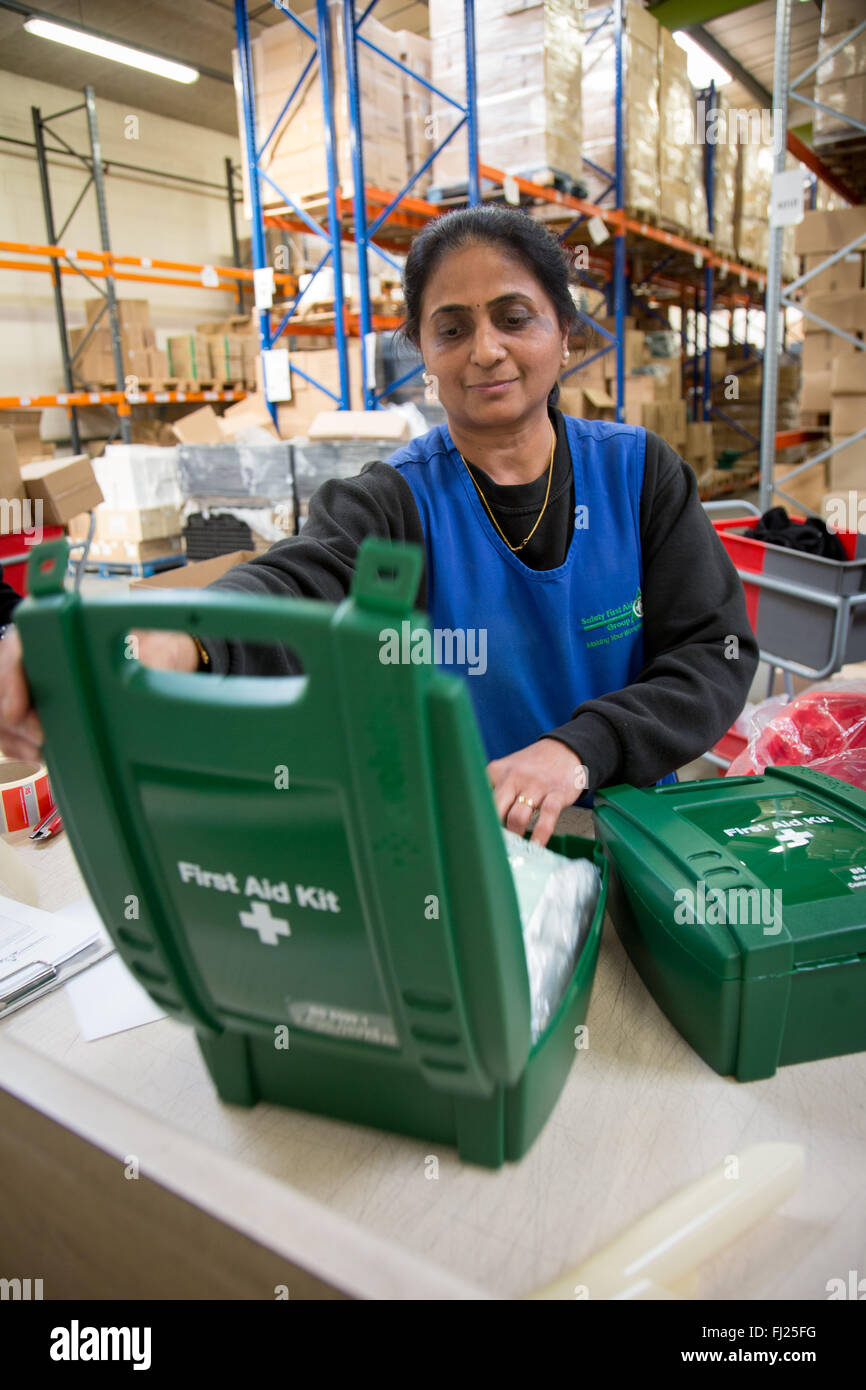 Woman packing First Aid Kit Boxes in a Warehouse in Hendon, London, England Stock Photo