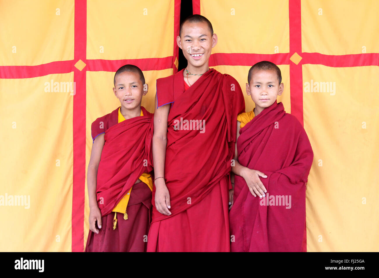 Portrait of 3 Nepali buddhist monks in Boudhanath Stock Photo