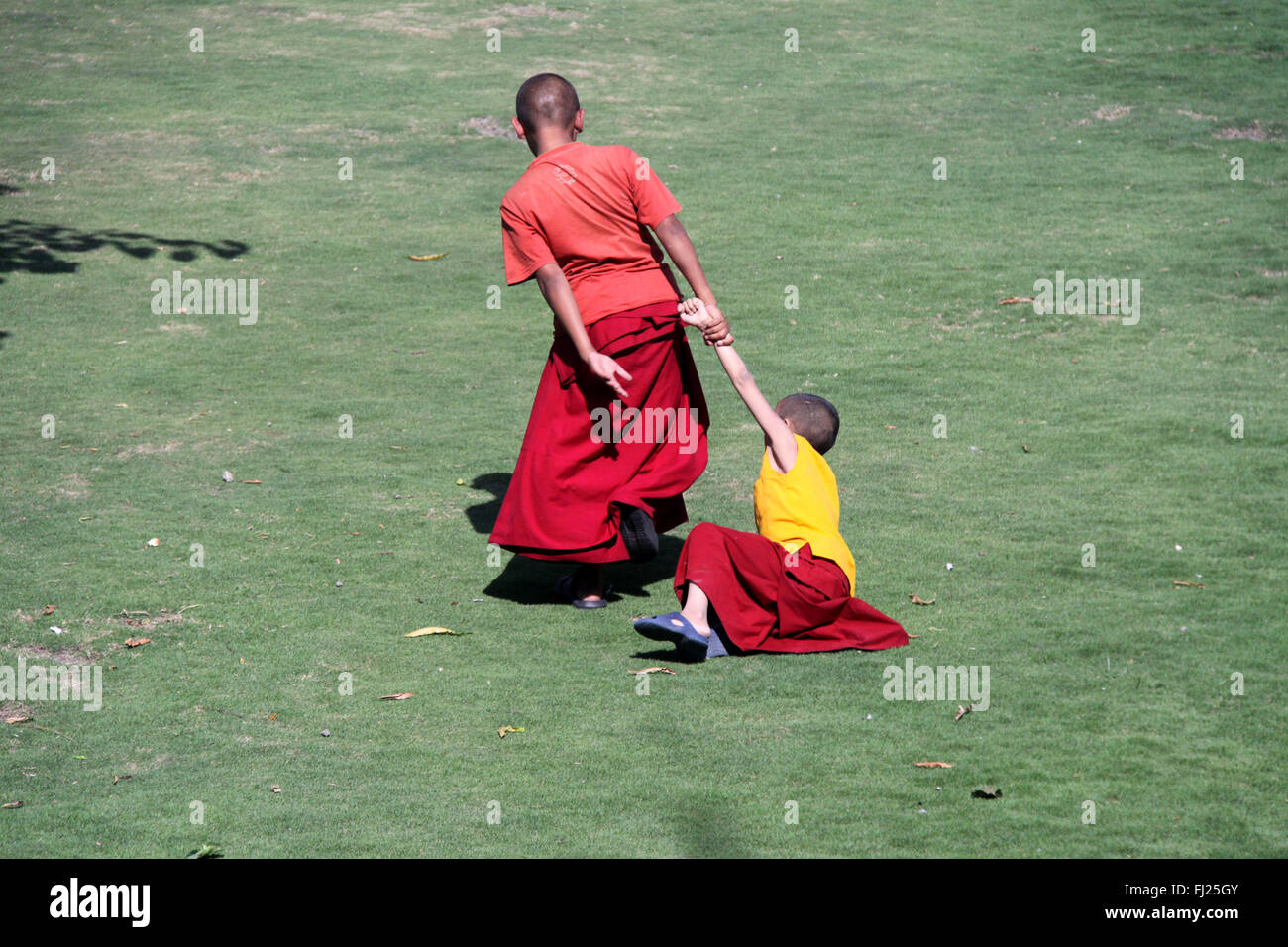 Buddhist monks are playing in monastery gompa in Boudhanath, Nepal Stock Photo