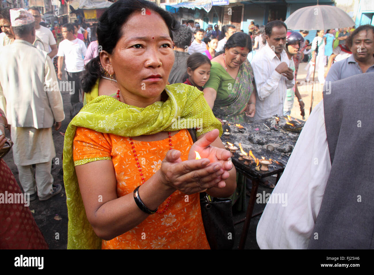 Woman praying / paking puja in Patan Stock Photo