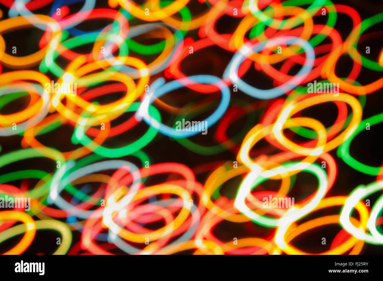 Multi-colored spots of light against a black background Stock Photo