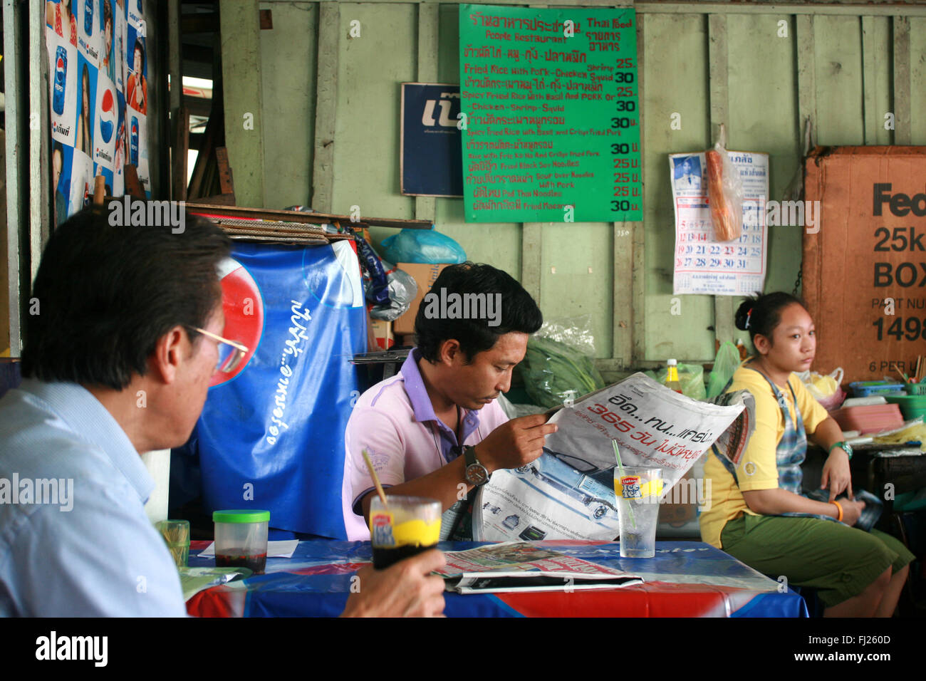 Streetlife in Bangkok - reading man Stock Photo