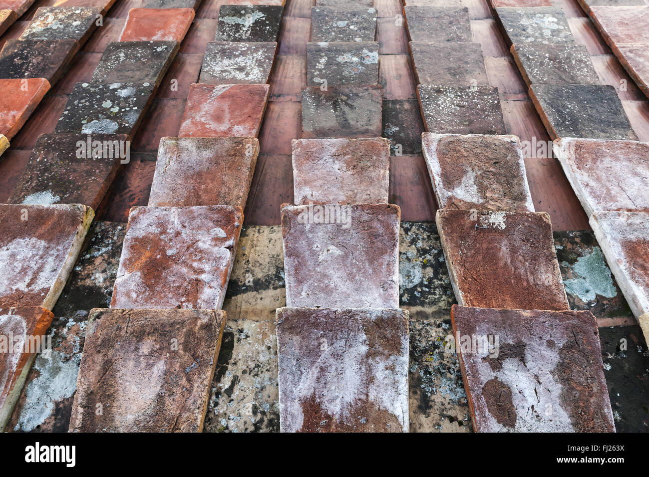 Old weathered red tile roof background texture with perspective effect Stock Photo