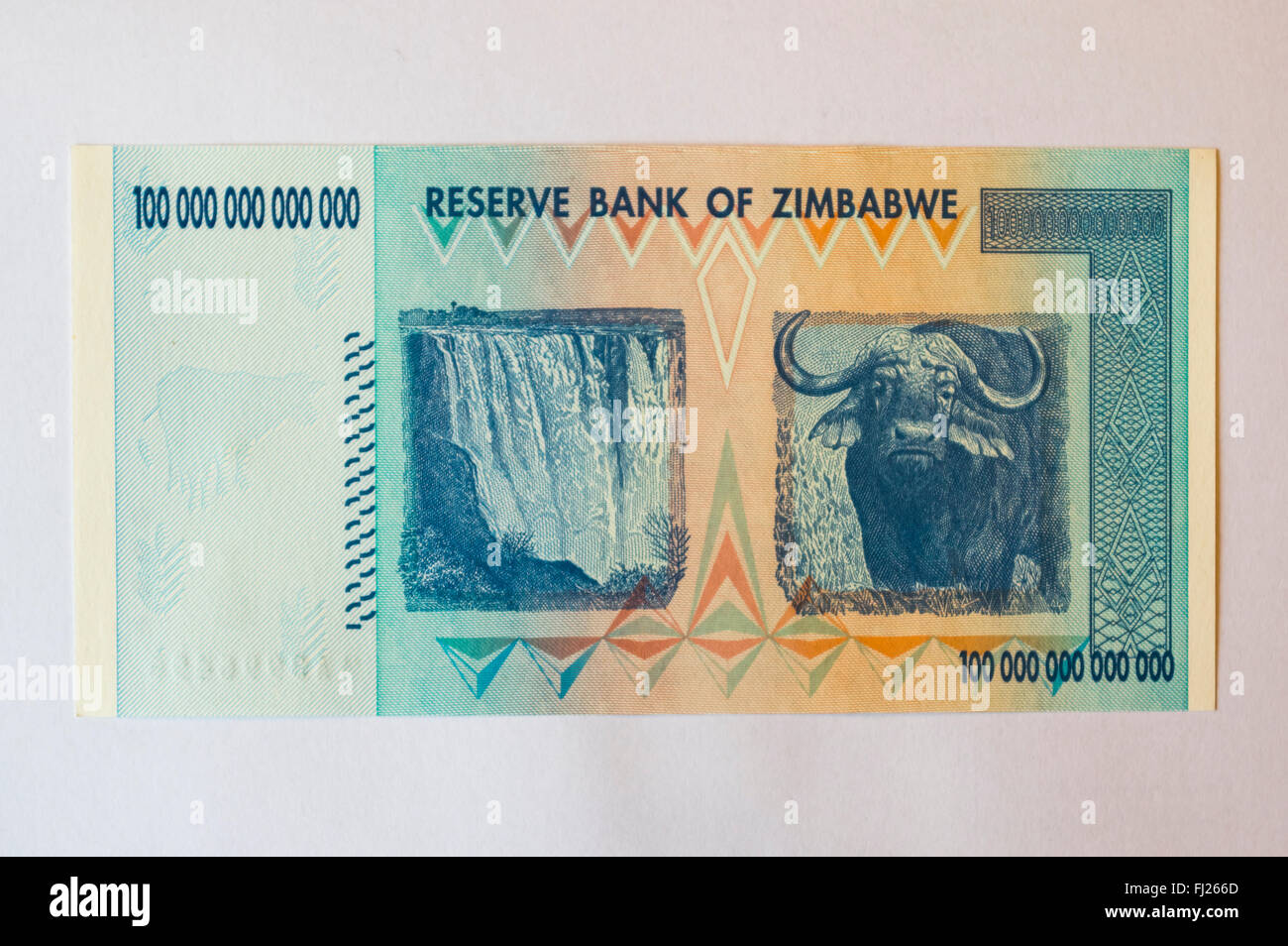 One hundred trillion dollars banknote issued in Zimbabwe in 2008, on the climax of the hyperinflation. White background. Stock Photo