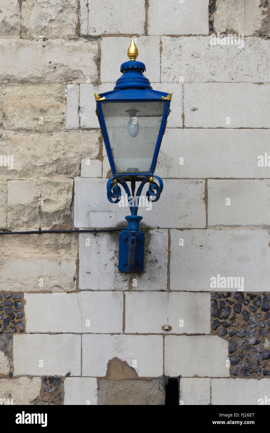 Old Blue Iron lamp on a stone wall Stock Photo