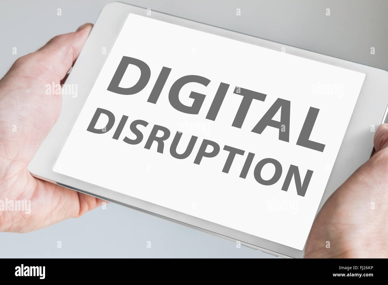 Digital disruption text displayed on touchscreen of modern tablet or smart device. Stock Photo