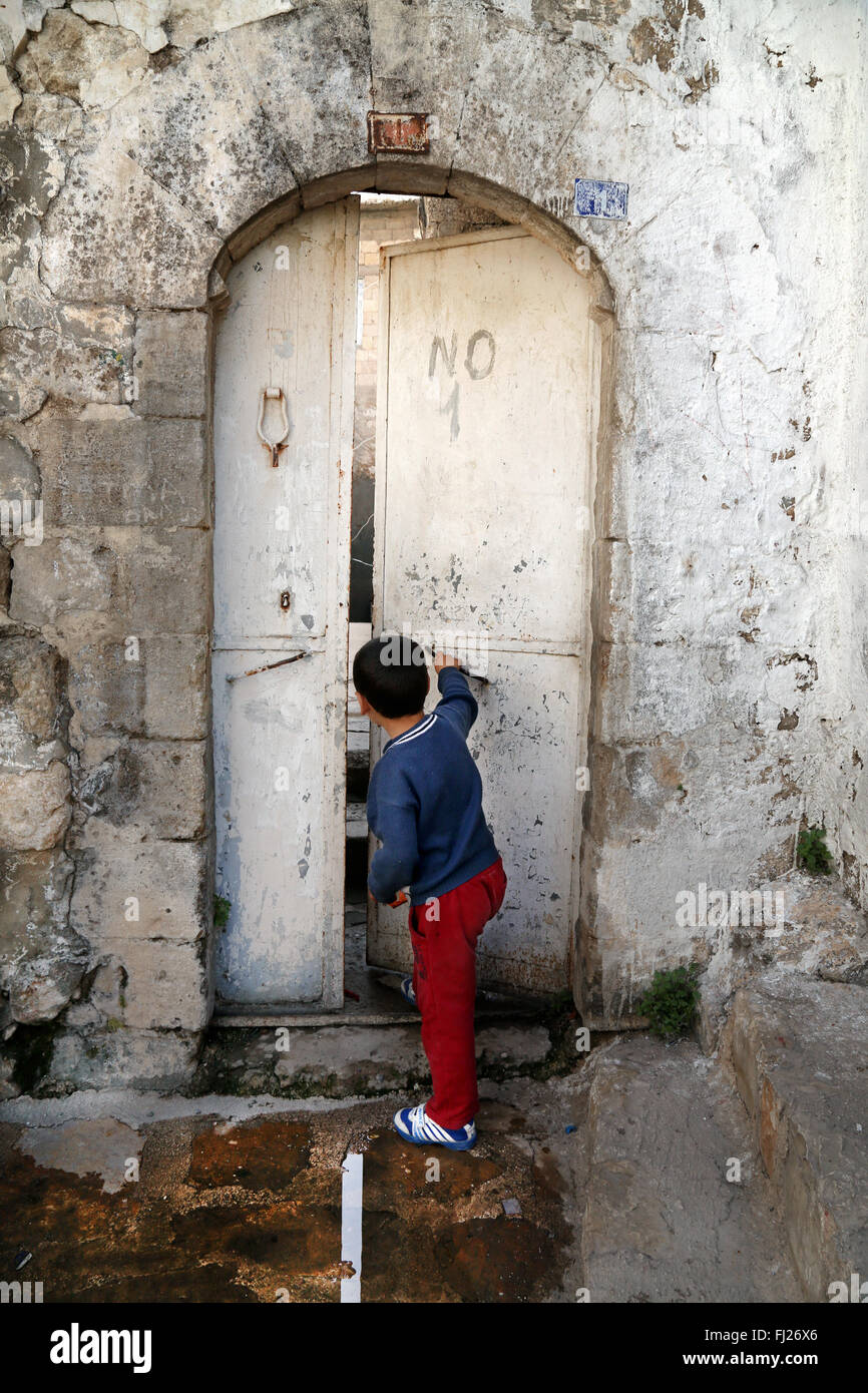 Child opening door in Mardin, Turke Stock Photo