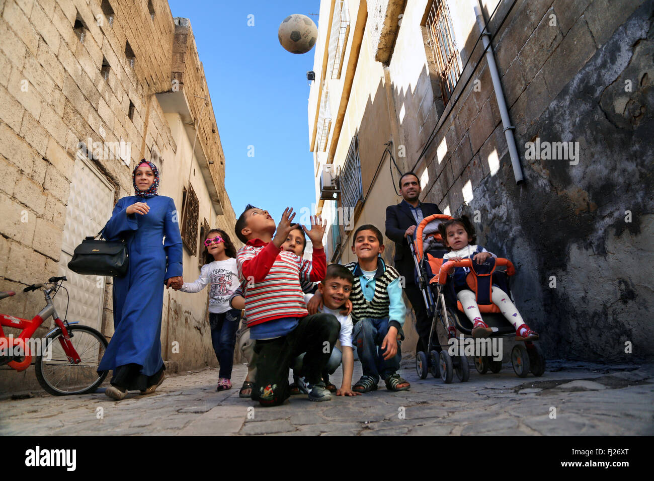 Kid playing with a ball in the streets of Diyarbaklir, Easter Turkey Stock Photo