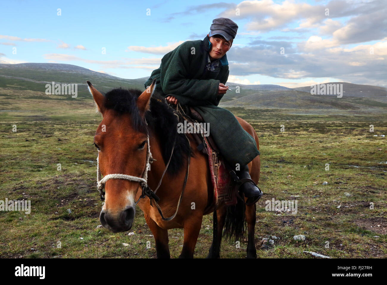 Young man on horse, , Tsaatan Dukha people , nomadic reindeer herders , Mongolia Stock Photo