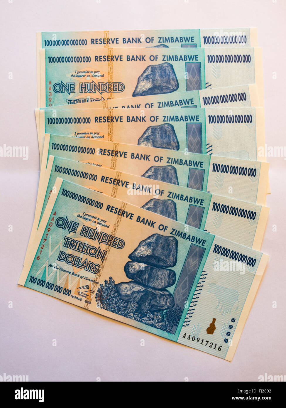 Bunch of one hundred trillion dollars banknotes issued in Zimbabwe in 2008, on the climax of the hyperinflation. Stock Photo