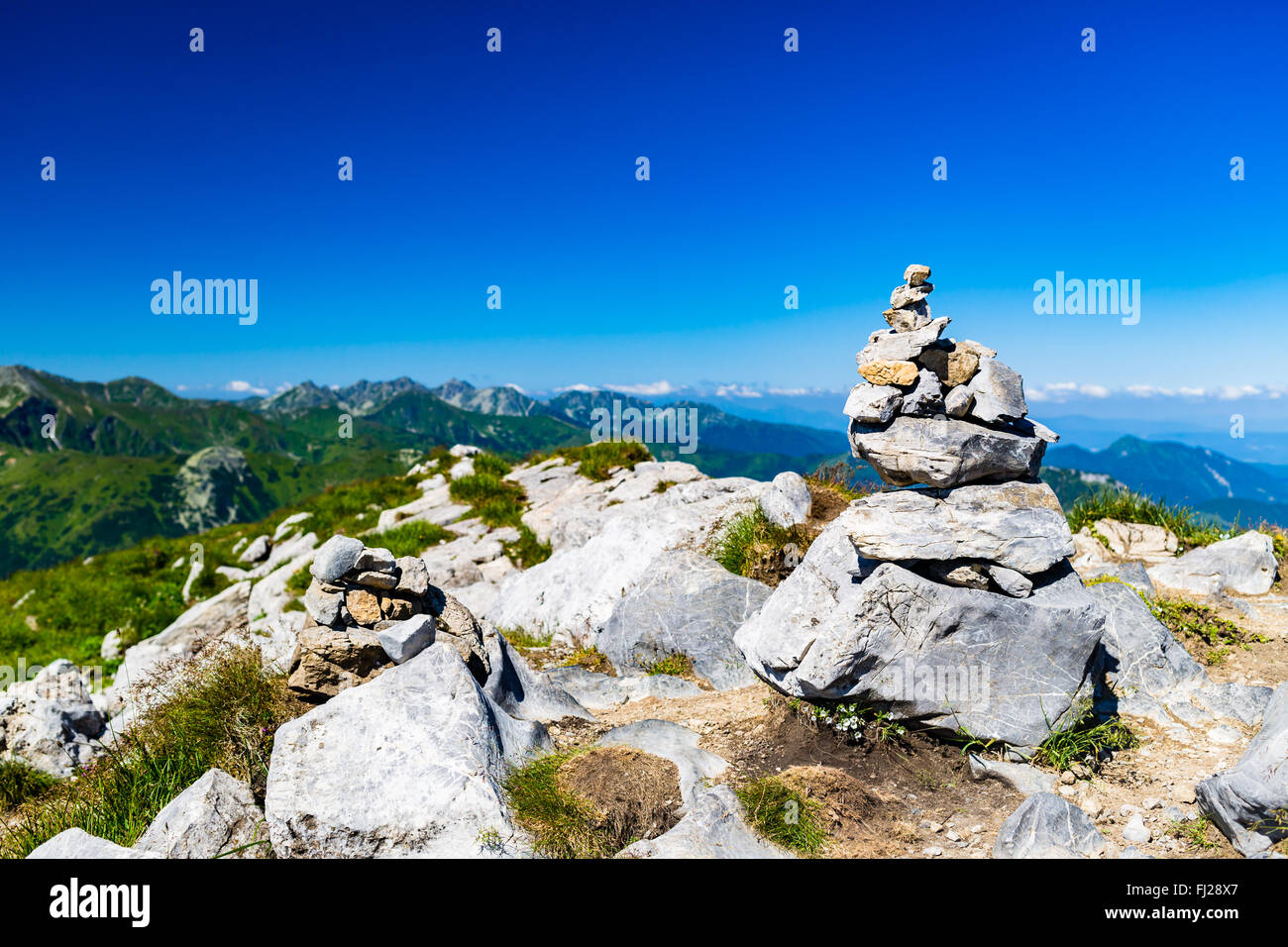 Inspiring Mountains Landscape View with Stones Balance Hiking Sign, sunny day in summer West Tatras, mountain ridge blue sky Stock Photo