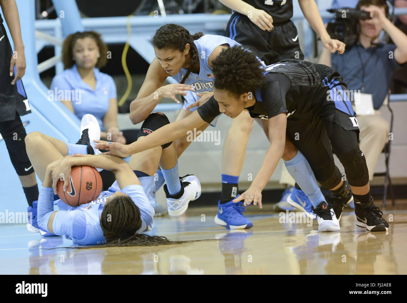 February 28, 2016 - Chapel Hill, North Carolina, USA - HILLARY SUMMERS, left, of North Carolina holds on to a loose ball against CRYSTAL PRIMM, right, of Duke with assistance from her teammate ERIKA JOHNSON, center. The University of North Carolina Tar Heels hosted the Duke Blue Devils at the Carmichael Arena in Chapel Hill, N.C. (Credit Image: © Fabian Radulescu via ZUMA Wire) Stock Photo