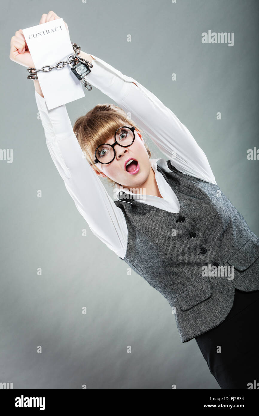 Business concept. Serious businesswoman with chained hands holding contract Stock Photo