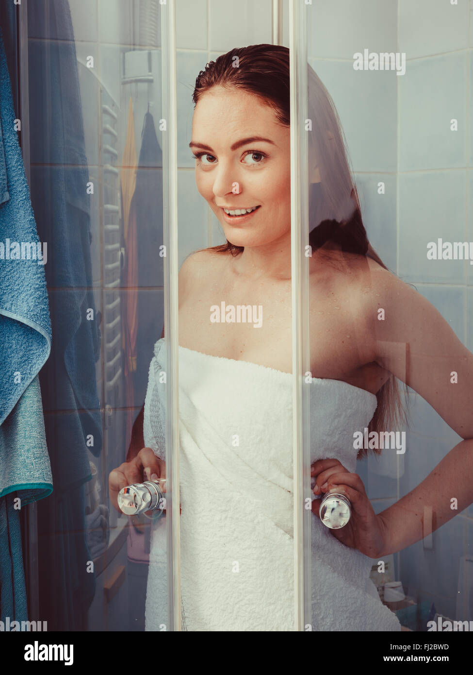 Girl showering in shower cabin enclosure. Woman taking care of hygiene in  bathroom Stock Photo - Alamy