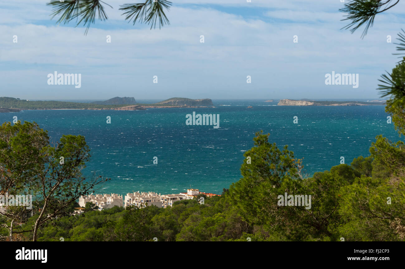 Hill side view from St Antoni de Portmany, Ibiza, into balearic sea on a clearing day in November, famous distant Conejera islan Stock Photo