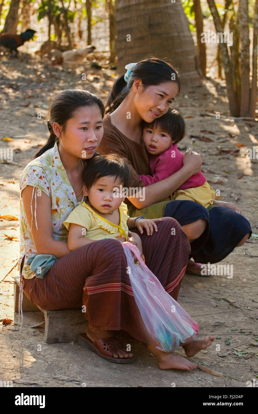 Young village mothers and daughters near LUANG PROBANG - LAOS Stock Photo