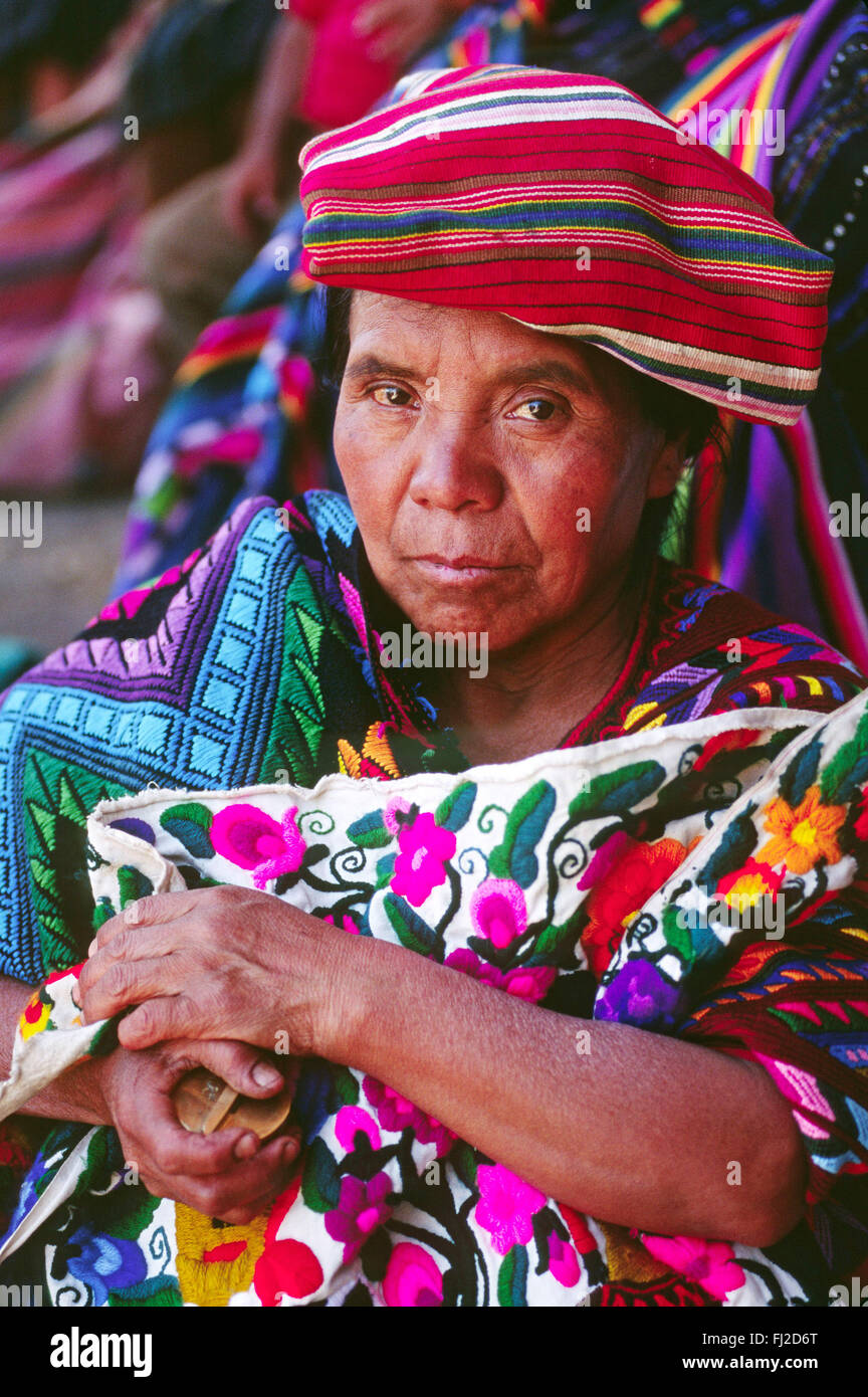 MAYAN WOMAN wearing traditional brocade HUIPILS in MARKETPLACE - CHICHICASTENANGO, GAUTAMALA Stock Photo