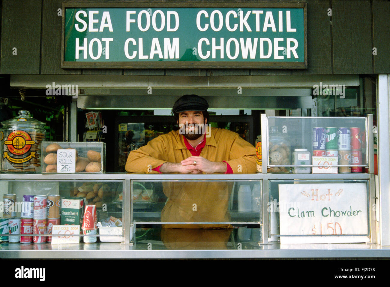 Salesman sells FISH to tourists at FISHERMAN'S WHARF - SAN FRANCISCO, CALIFORNIA Stock Photo