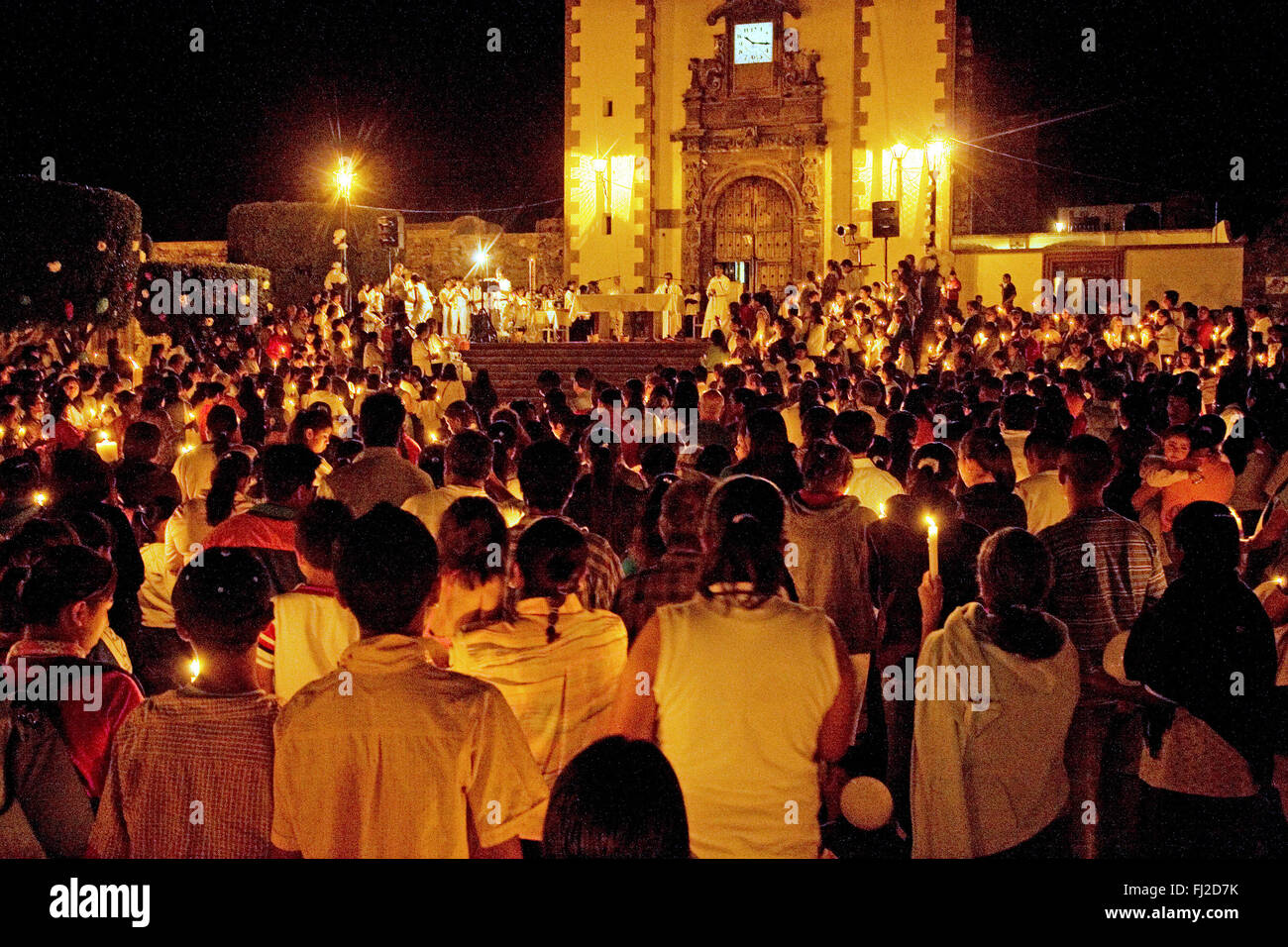 Catholics light candles during easter mass hires stock photography and