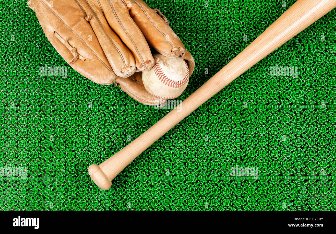 Overhead view of baseball mitt, ball and bat on artificial grass Stock