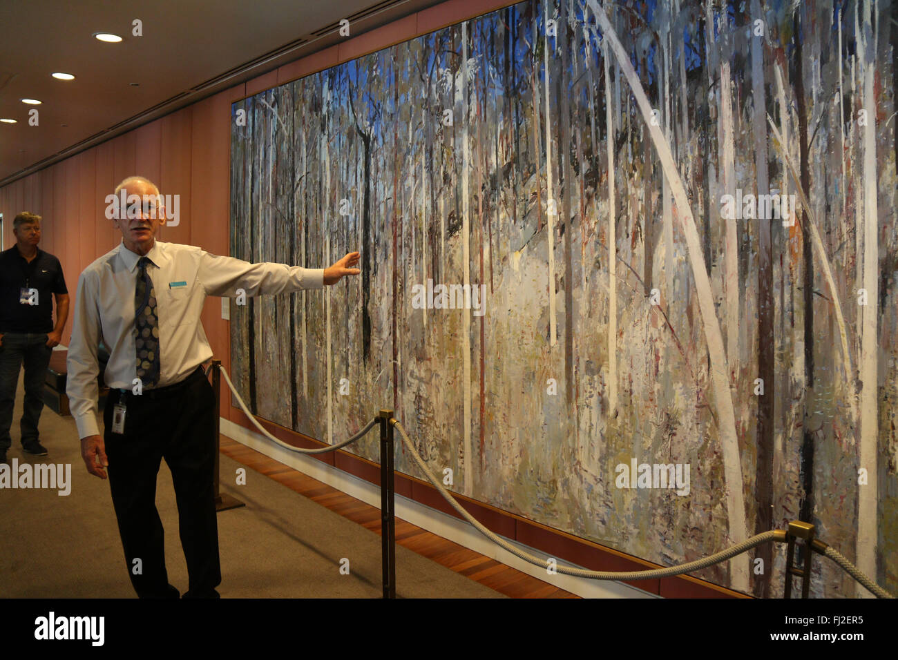 Visitors are told about a painting during a free guided tour of the Australian Parliament House at Capital Hill in Canberra. Stock Photo