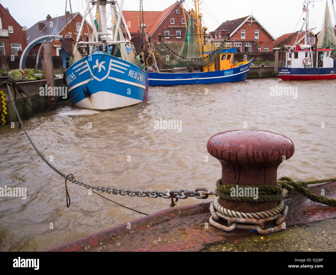 Neuharlingersiel, Germany - Dezember 25, 2014: Fishing boats with ropa and poller in Neuharlingersiel Stock Photo