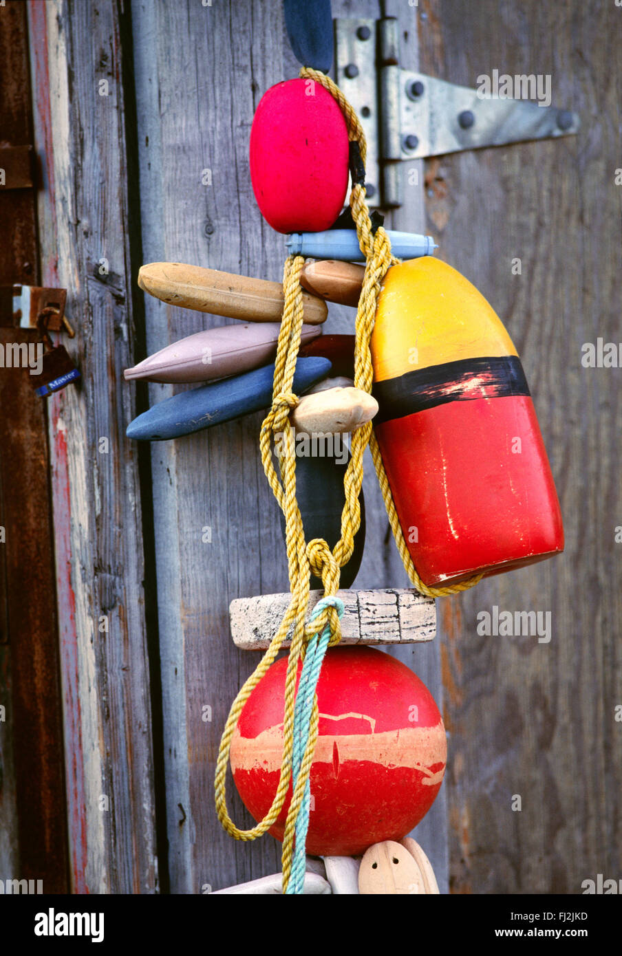 Colored Fishing Net Floats On Red Wall Stock Photo - Download