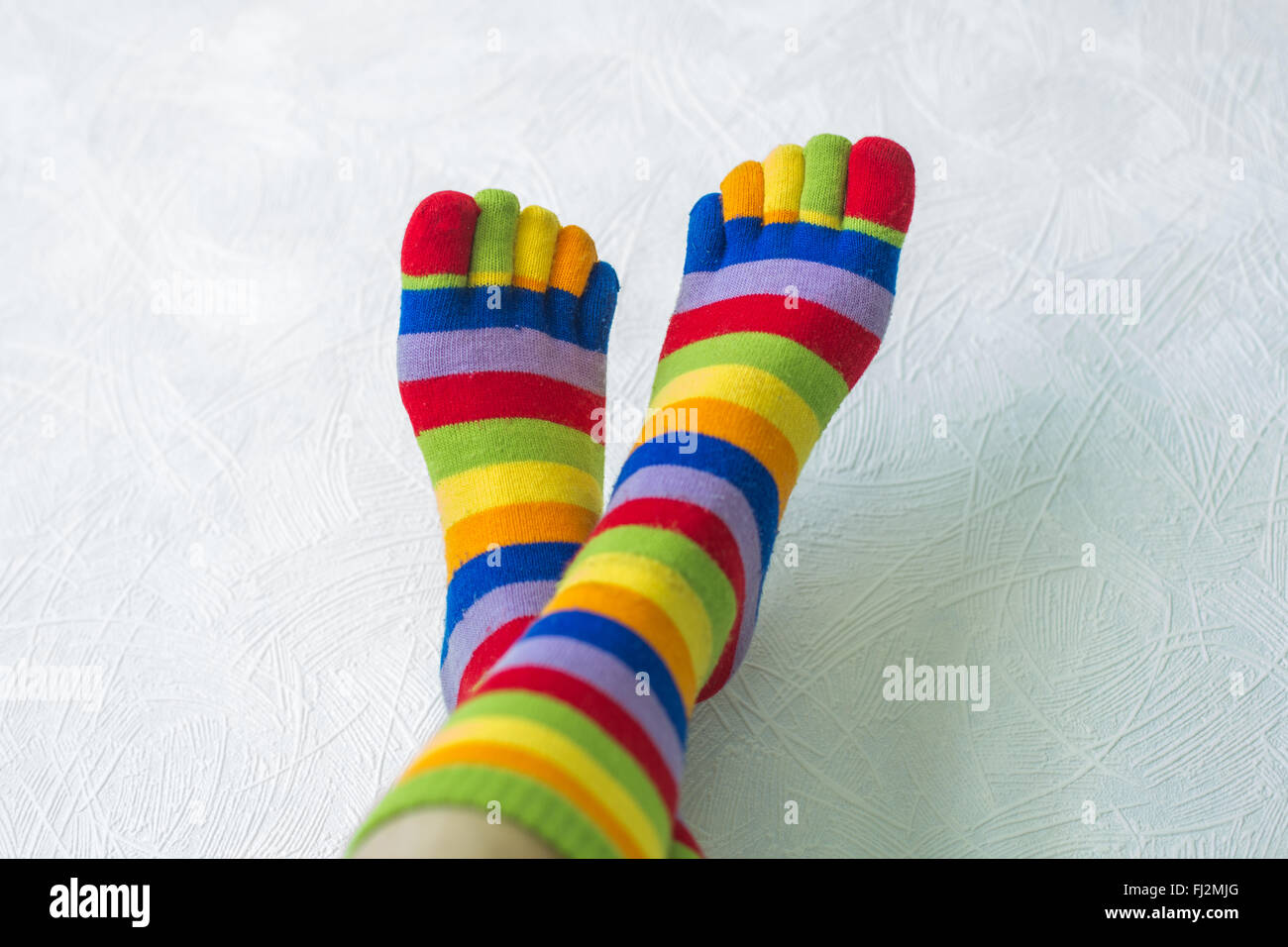 Woman feet in multicolored striped socks stock photo (160474) -  YouWorkForThem