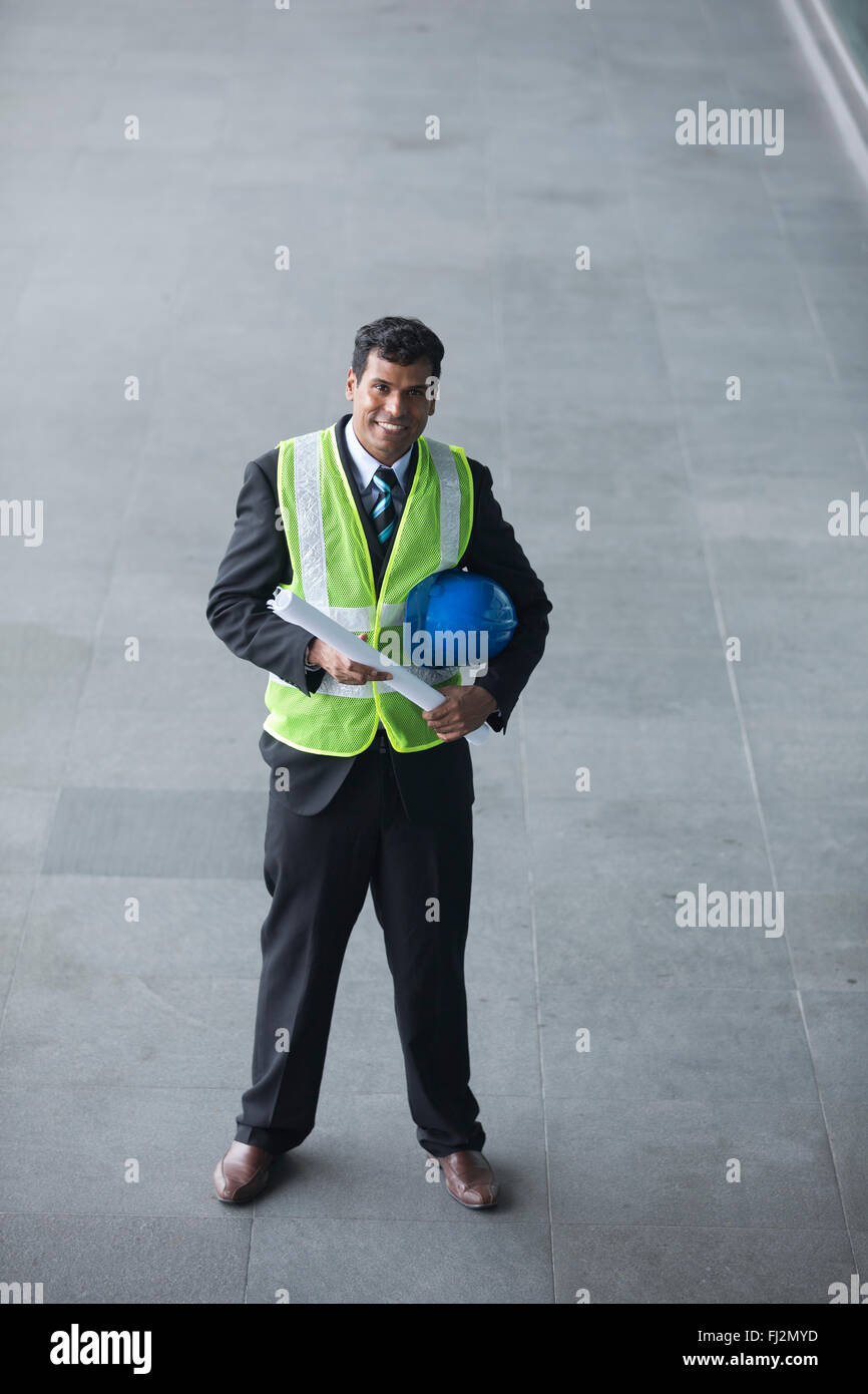 High angle view of an Indian Architect or industrial engineer at work ...