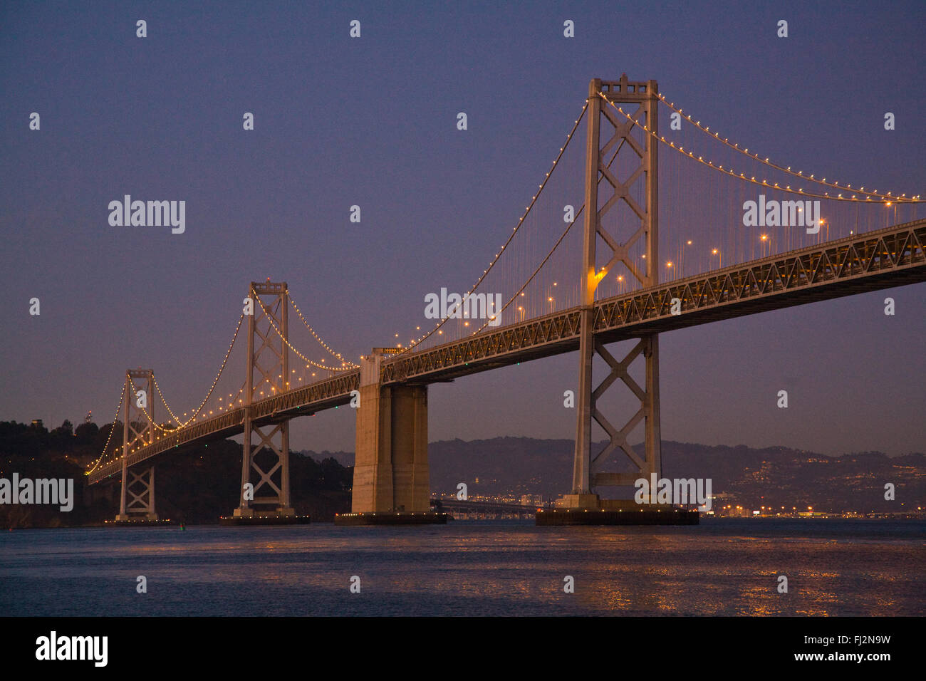 The BAY BRIDGE at night from THE EMBARCADERO - SAN FRANCISCO, CALIFORNIA Stock Photo