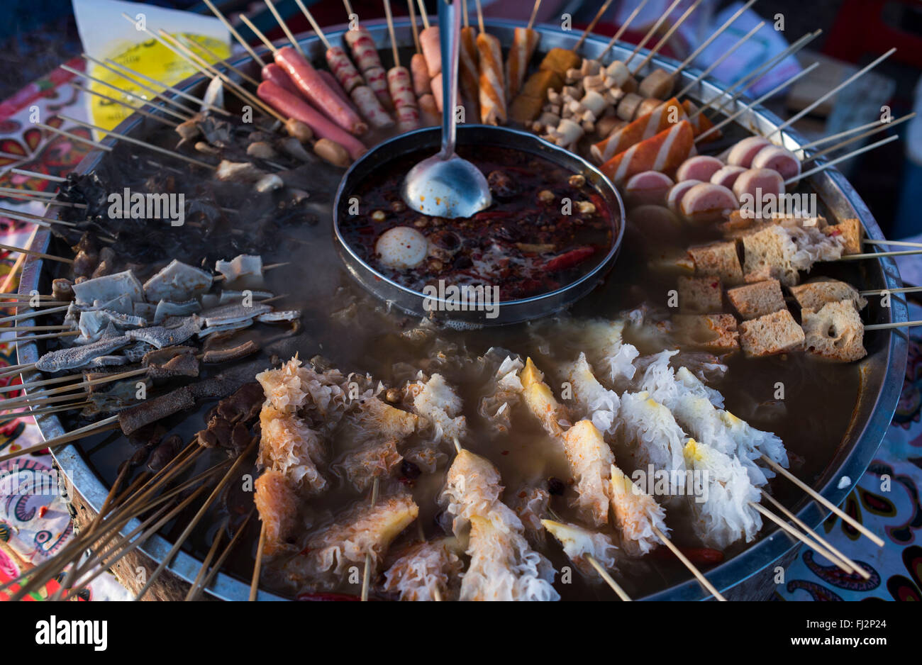 Yutian. 27th Feb, 2016. Photo taken on Feb. 27, 2016 shows snacks on a bazaar in Xambabazar Town of Yutian County, northwest China's Xinjiang Uygur Autonomous Region. Xambabazar, which means 'Saturday market' in Uigur, is part of life of local people, who enjoy tasty food on this special occasion. © Jiang Wenyao/Xinhua/Alamy Live News Stock Photo