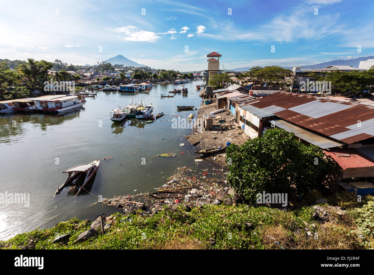 poor houses with sheet tin by the river, Kota Manado, North Sulawesi