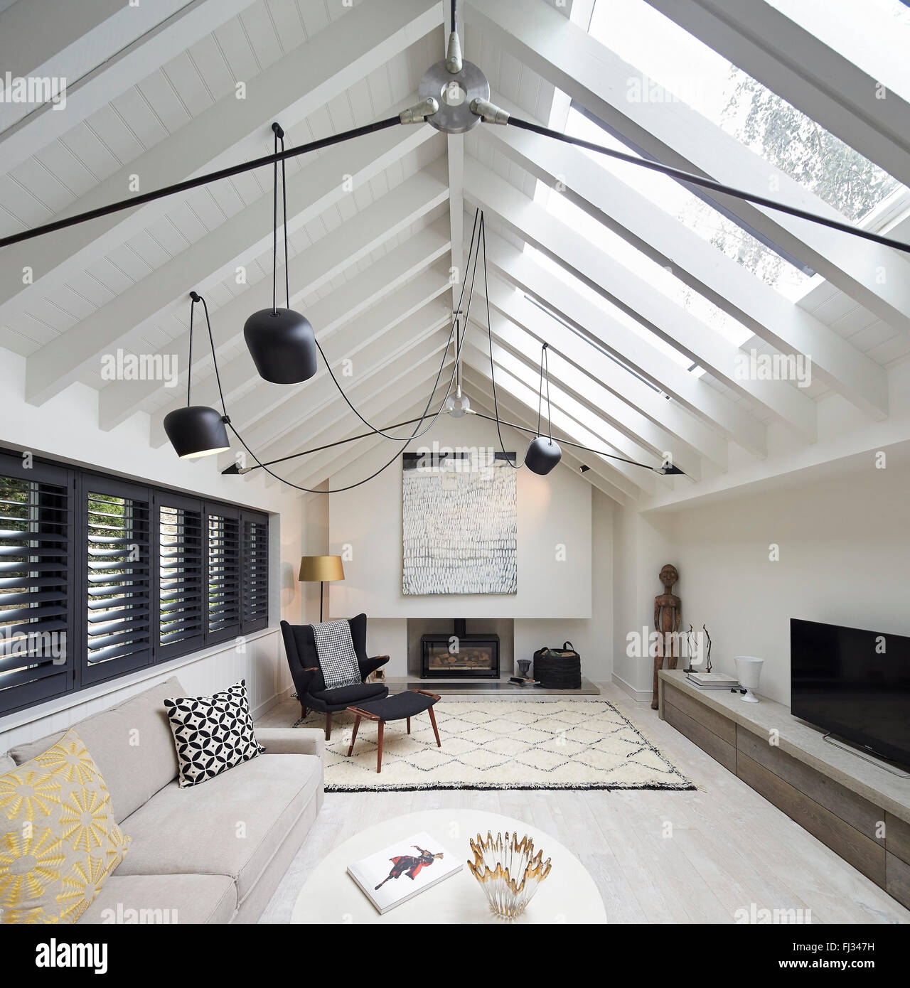 Living space with exposed gabled ceiling. Orleans Road, Twickenham, United Kingdom. Architect: Burwell Deakins Architects, 2015. Stock Photo