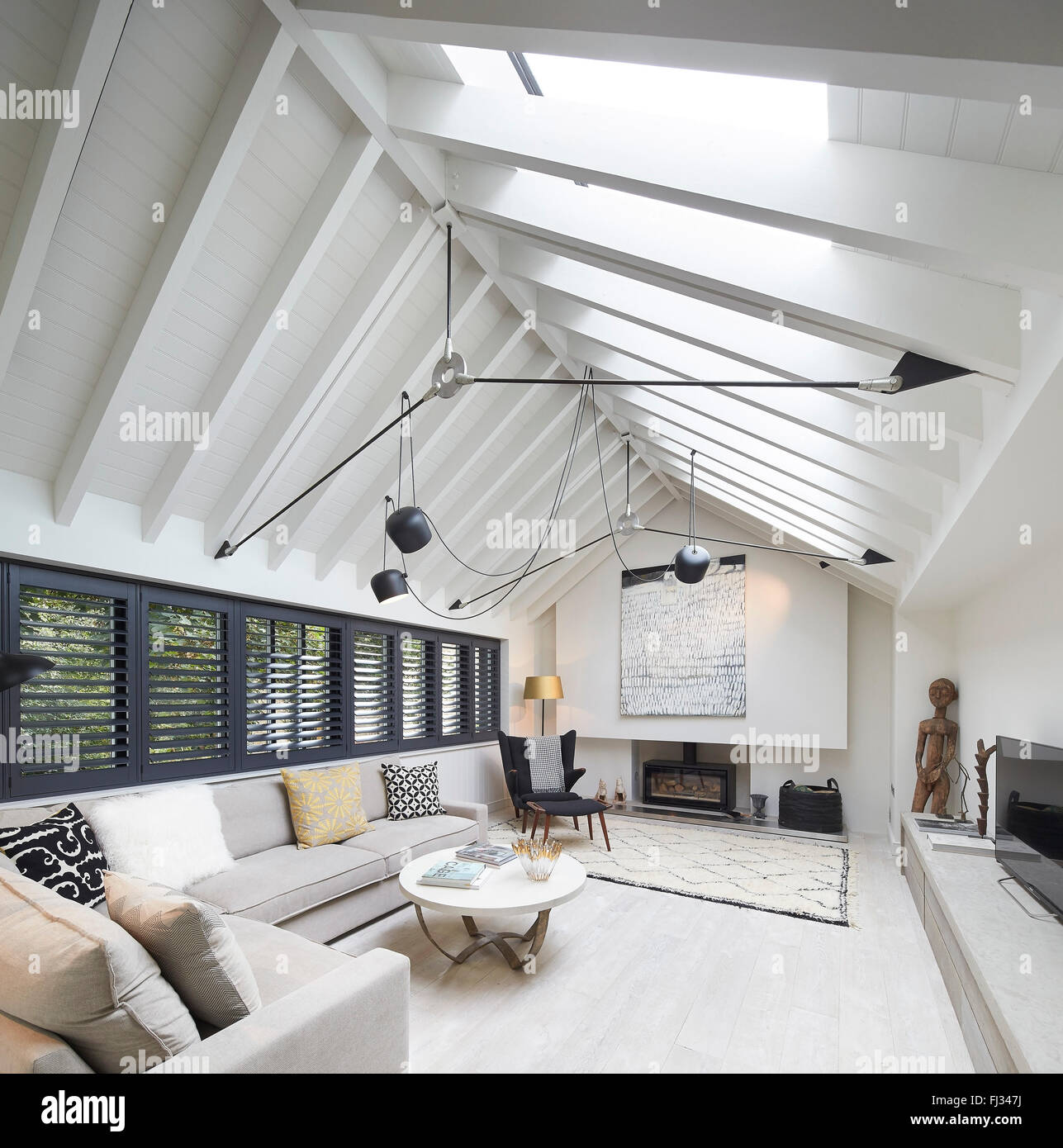Living space with exposed gabled ceiling. Orleans Road, Twickenham, United Kingdom. Architect: Burwell Deakins Architects, 2015. Stock Photo