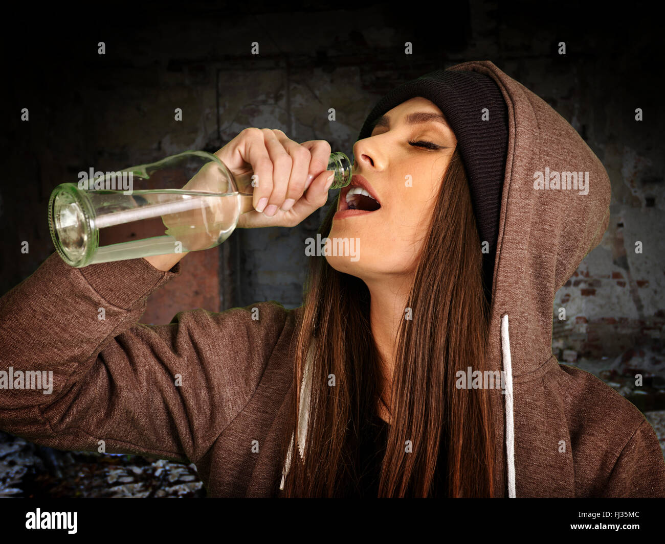 Drunk girl holding bottle of vodka Stock Photo - Alamy