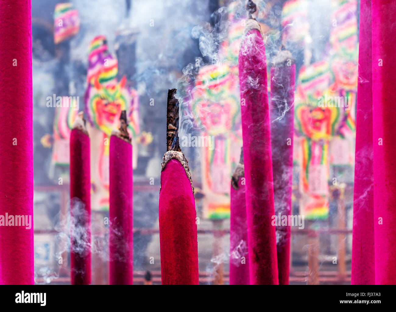 Chinese magenta colored  incenses with smoke Stock Photo