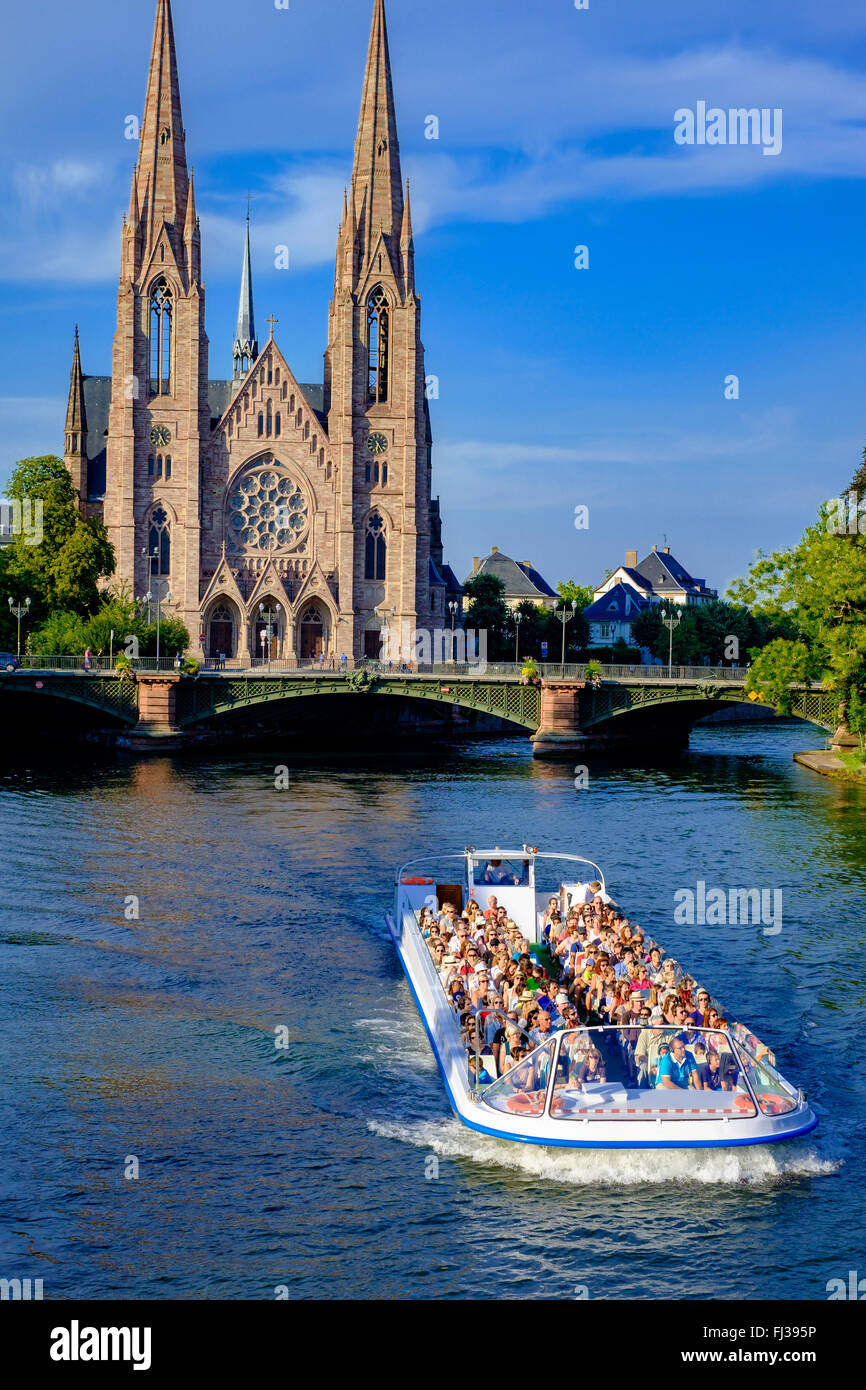 Sightseeing tour boat on Ill river and St Paul protestant church, Strasbourg, Alsace, France, Europe Stock Photo