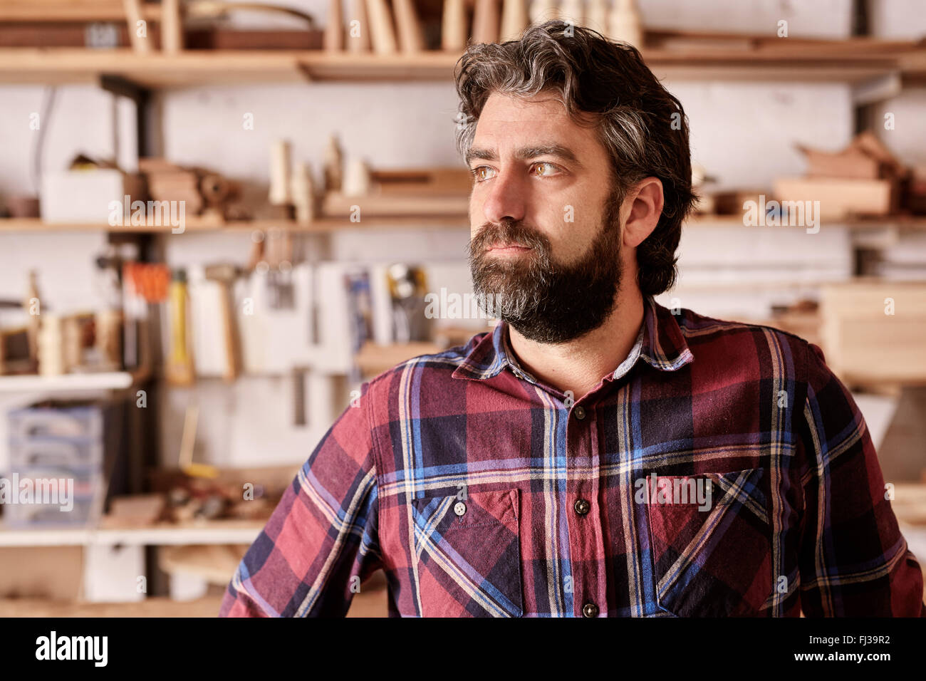 Artisan crafstman and business owner looking away seriously Stock Photo