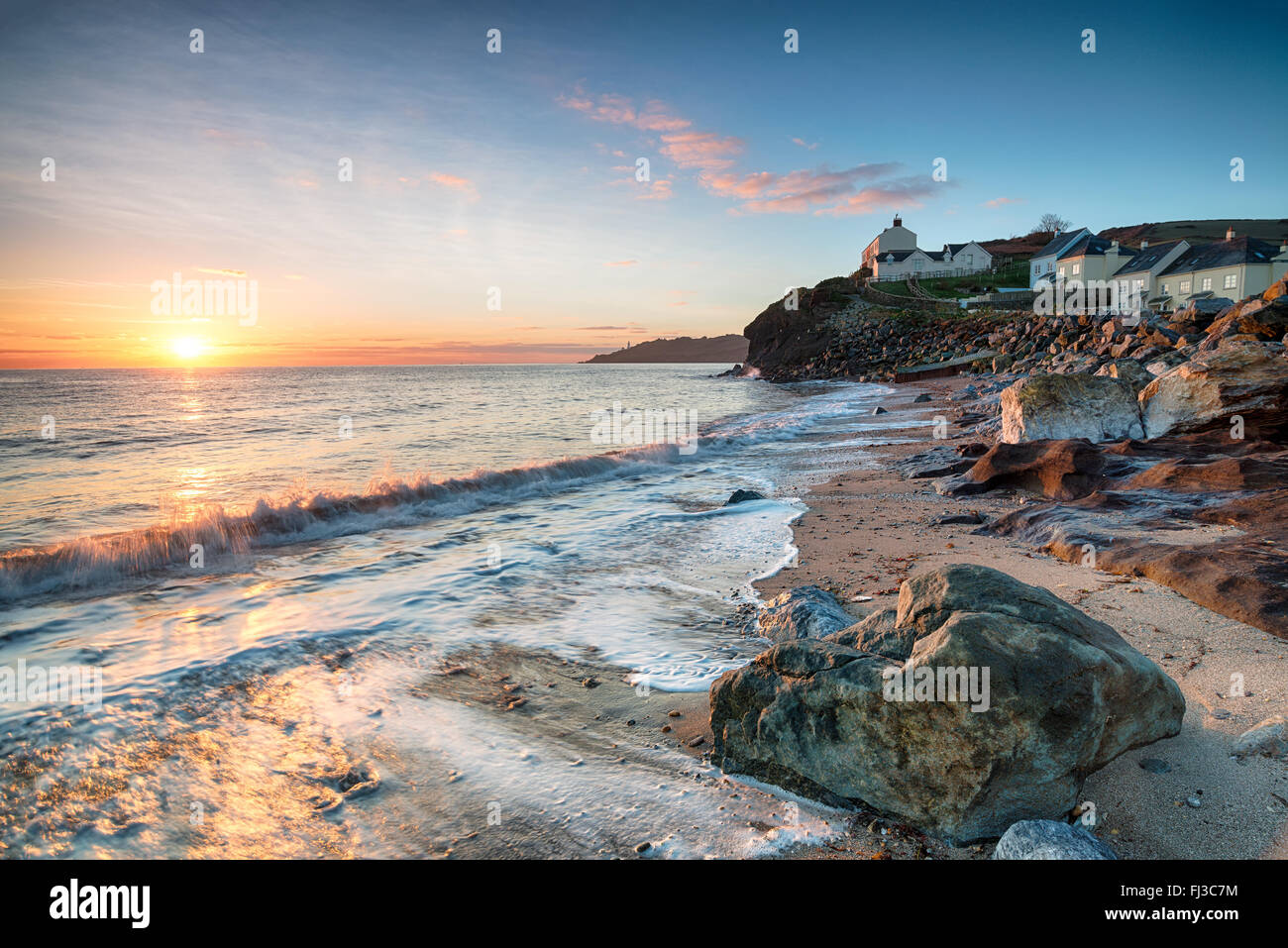 Sunrise over the beach and seaside cottages at Hallsands on the Devon coast Stock Photo