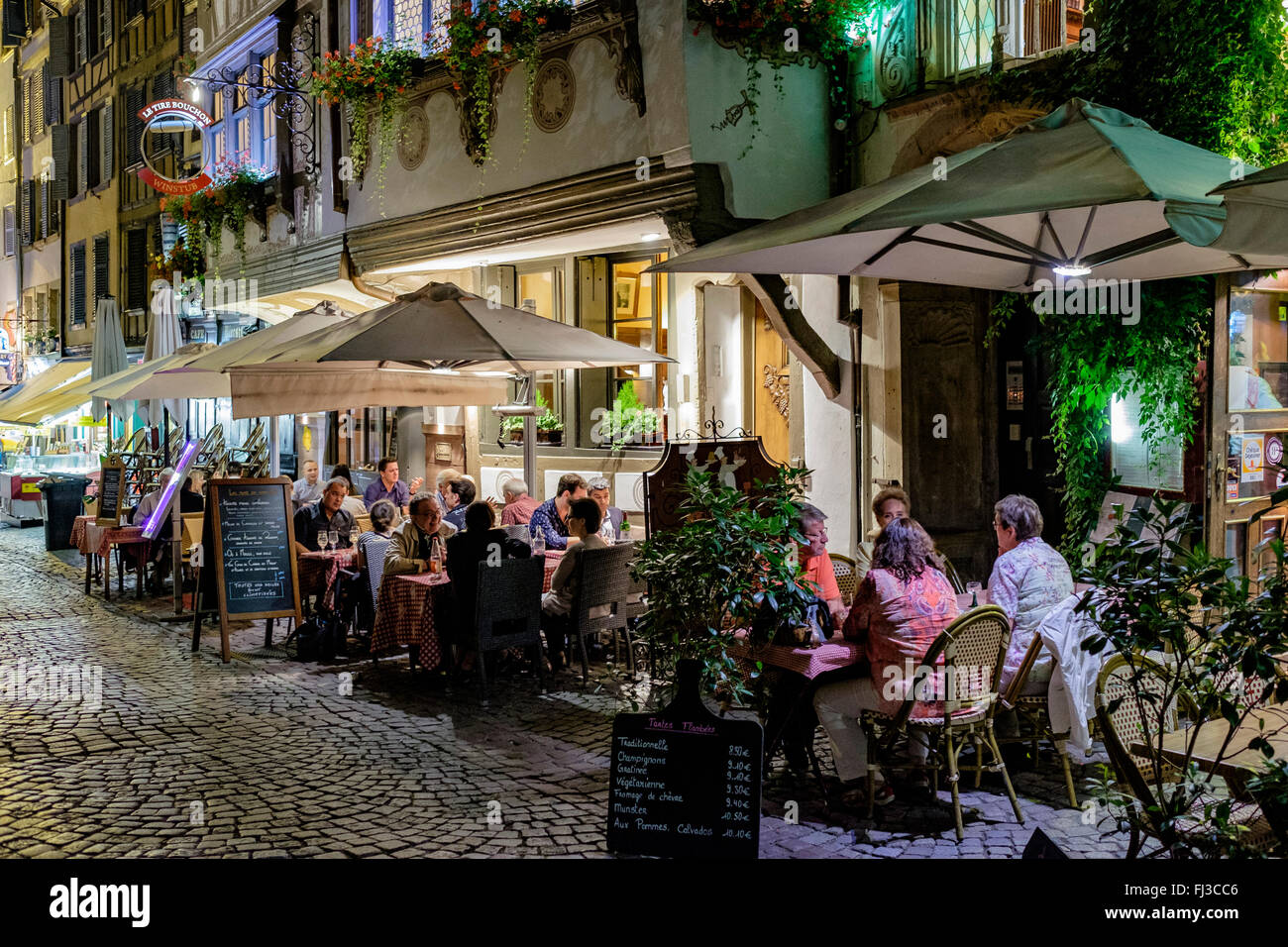 Restaurant street terrace at night, Strasbourg, Alsace, France, Europe Stock Photo
