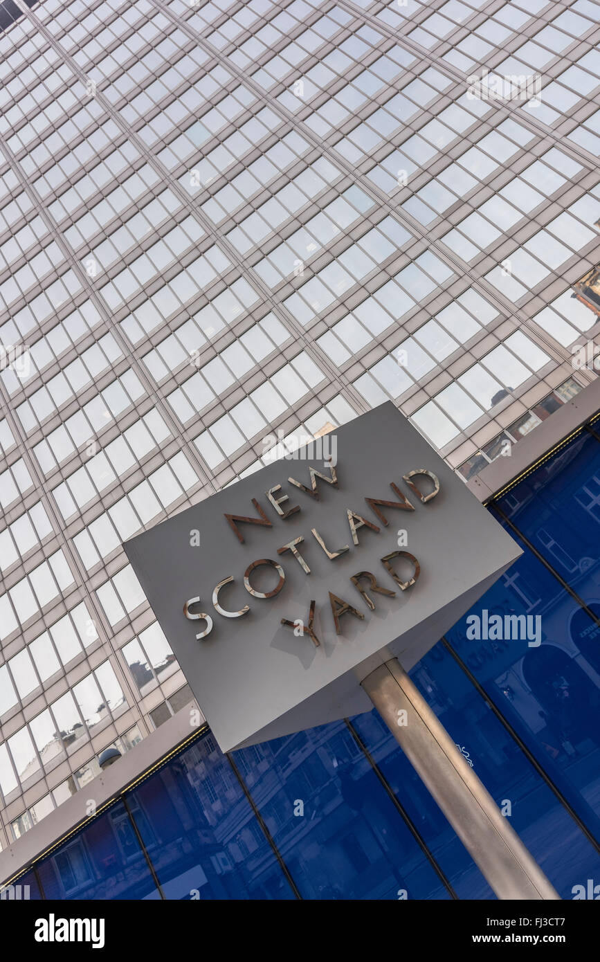 This triangular, revolving, sign stands outside New Scotland Yard which is the headquarters of the Metropolitan Police Service. Stock Photo