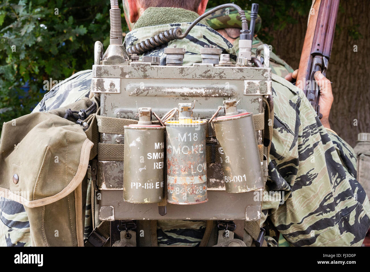 War and Peace show, England. Vietnam war re-enactment. American field radio  with three smoke canisters, two red, one yellow, on back, plus field pack  Stock Photo - Alamy